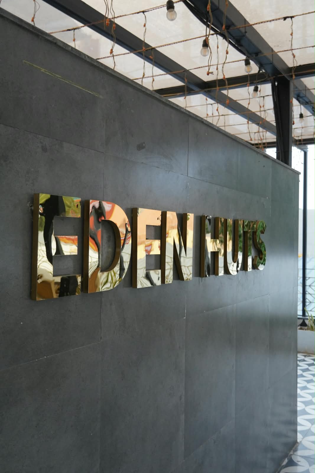 Eden Huts polished gold emblem